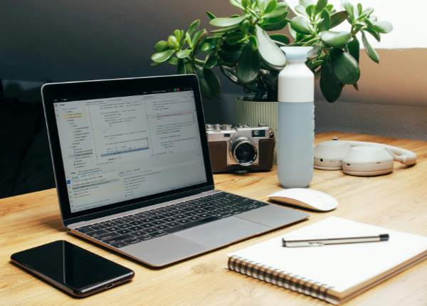 Ein Notebook und Notizbuch auf einem Tisch.